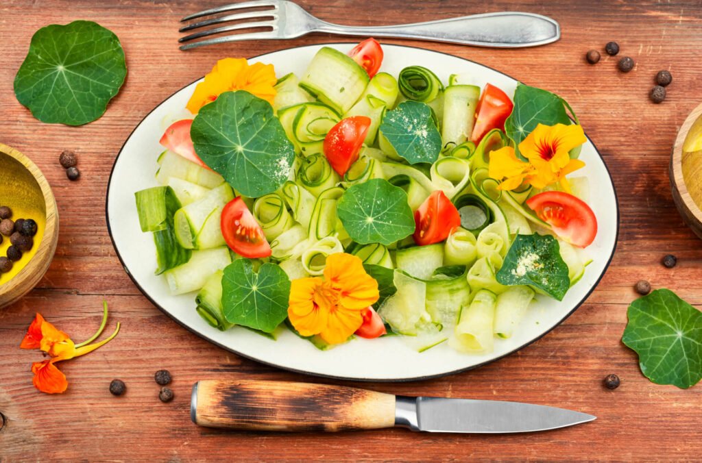 Fresh green salad with nasturtium leaves and flowers